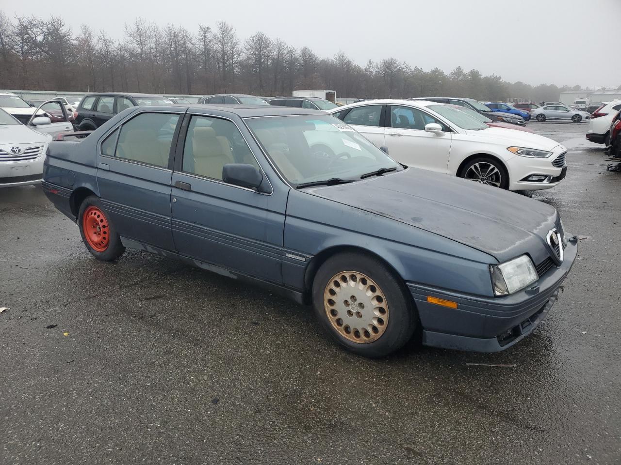 1991 Alfa Romeo 164 VIN ZAREA43L5M6171139 Copart auction photo, rear end / minor dent/scratches damage thumbnail 4
