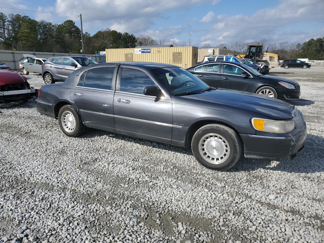 1999 Lincoln Town Car VIN 1LNHM81W4XY714116 Copart auction photo, side / minor dent/scratches damage thumbnail 4