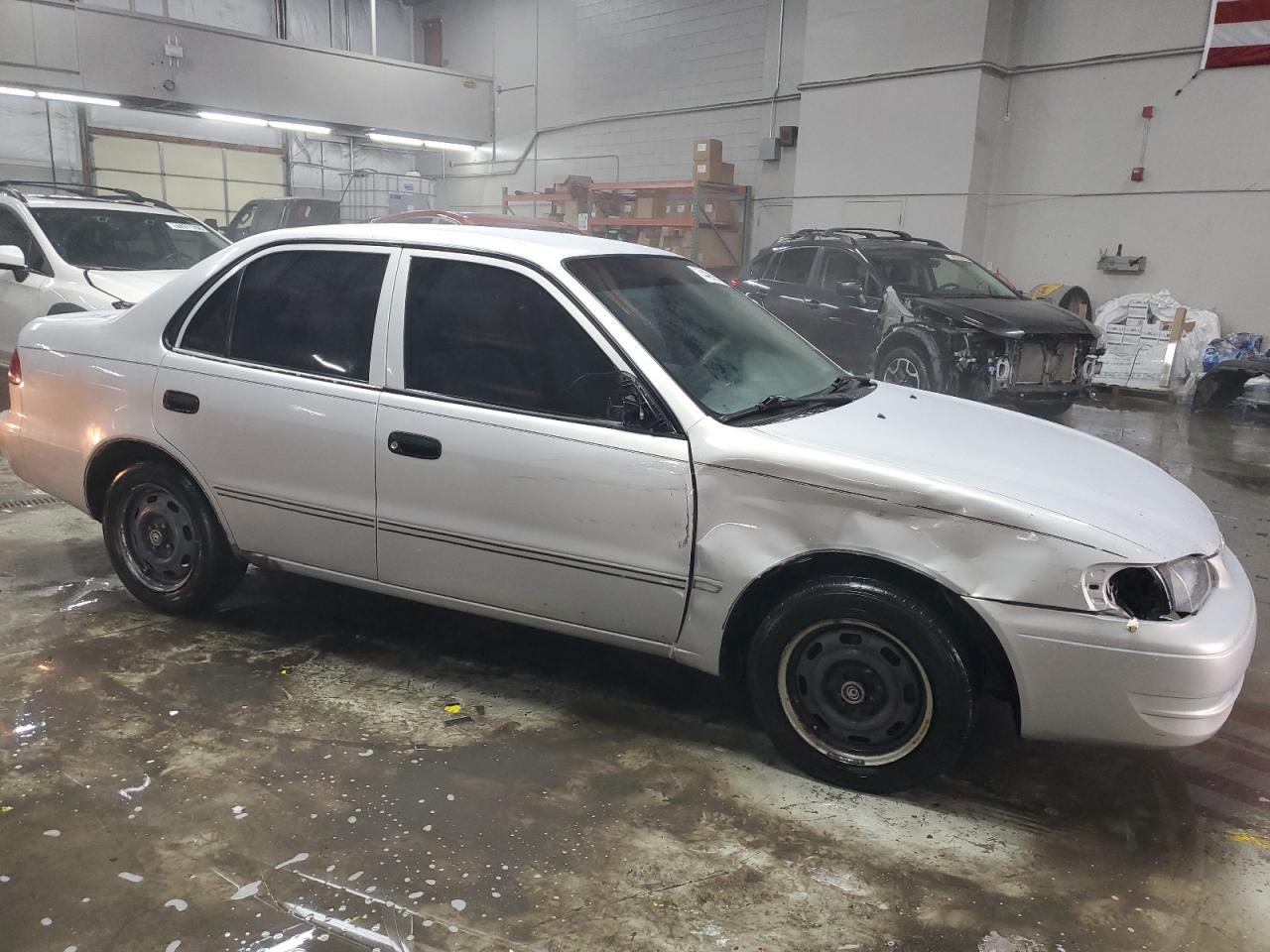 2000 Toyota Corolla VIN 1NXBR12E2YZ352302 Copart auction photo, front end / hail damage thumbnail 4