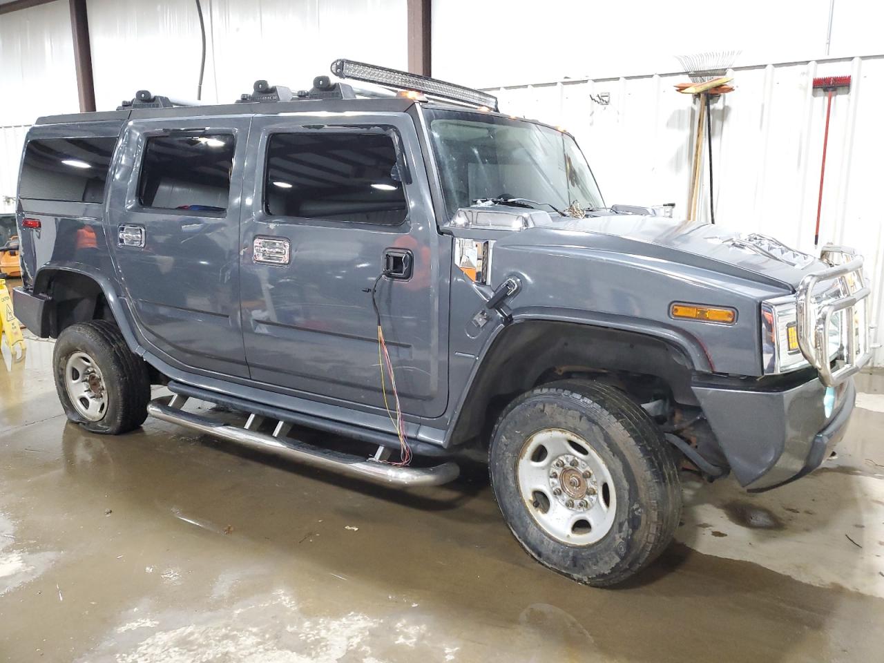 2003 Hummer H2 VIN 5GRGN23U73H127407 Copart auction photo, side / rear end damage thumbnail 4