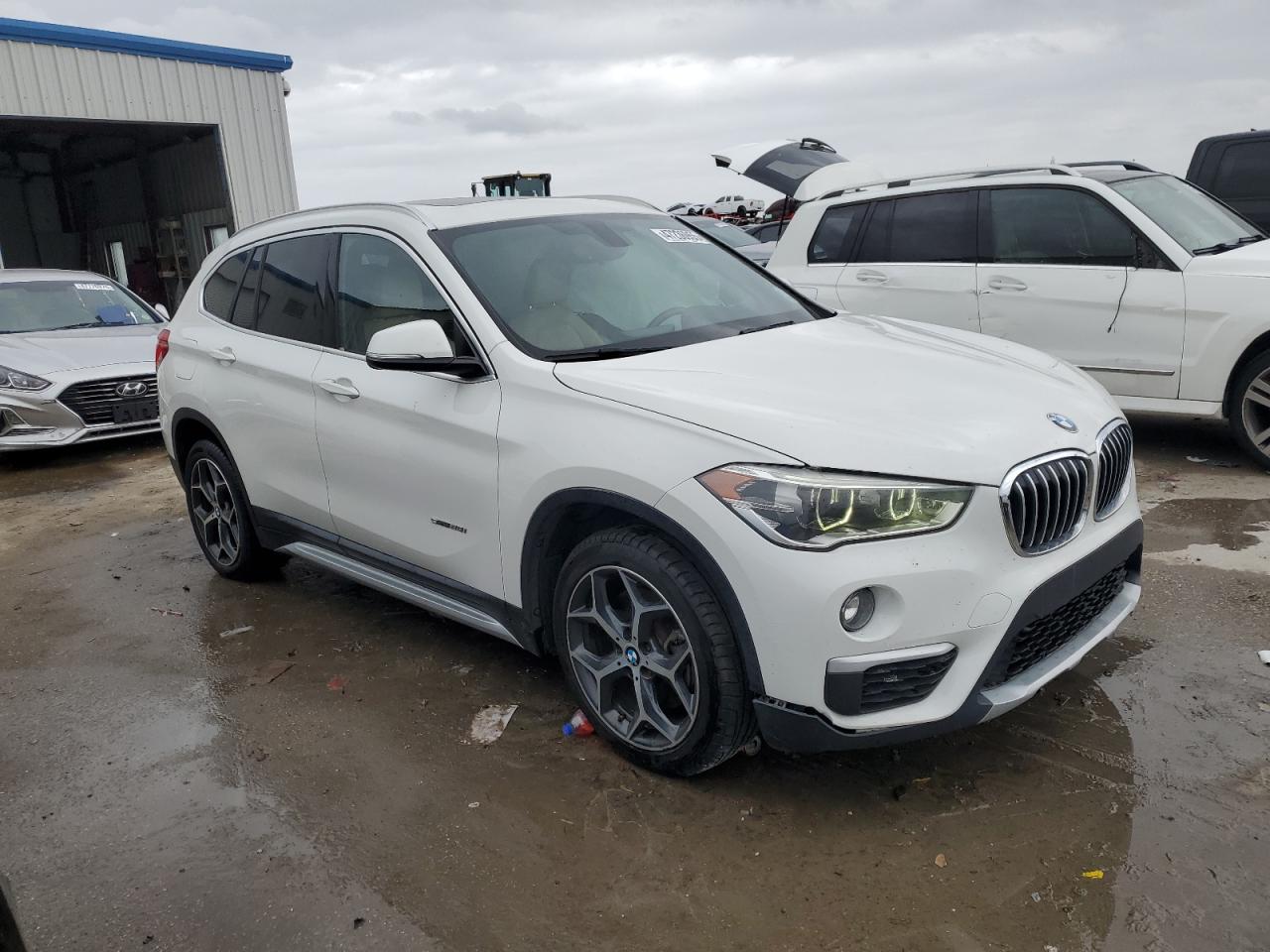 2018 BMW X1 VIN WBXHU7C30J5L04877 Copart auction photo, front end / side damage thumbnail 4