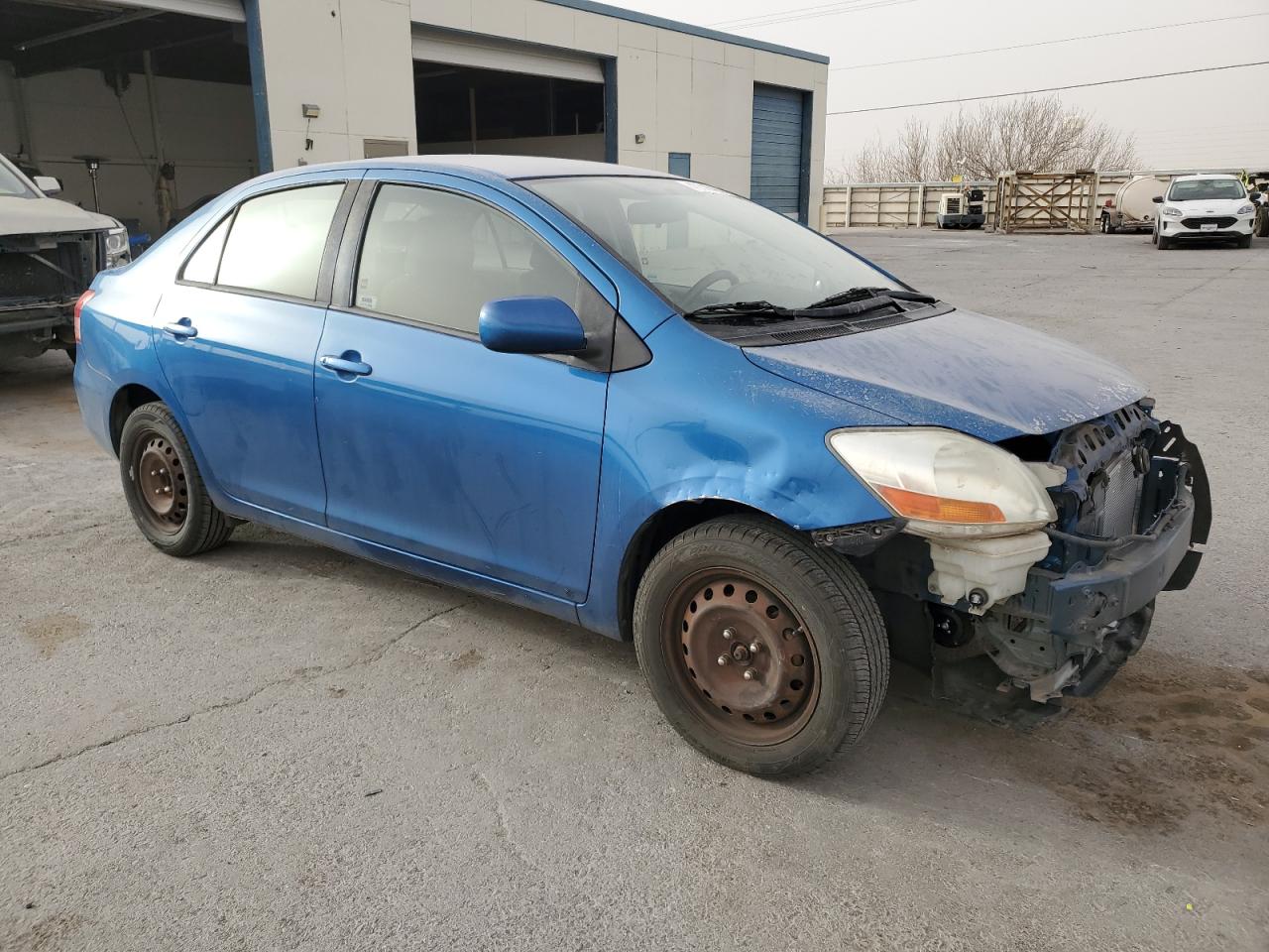 2009 Toyota Yaris VIN JTDBT903594045701 Copart auction photo, vandalism damage thumbnail 4
