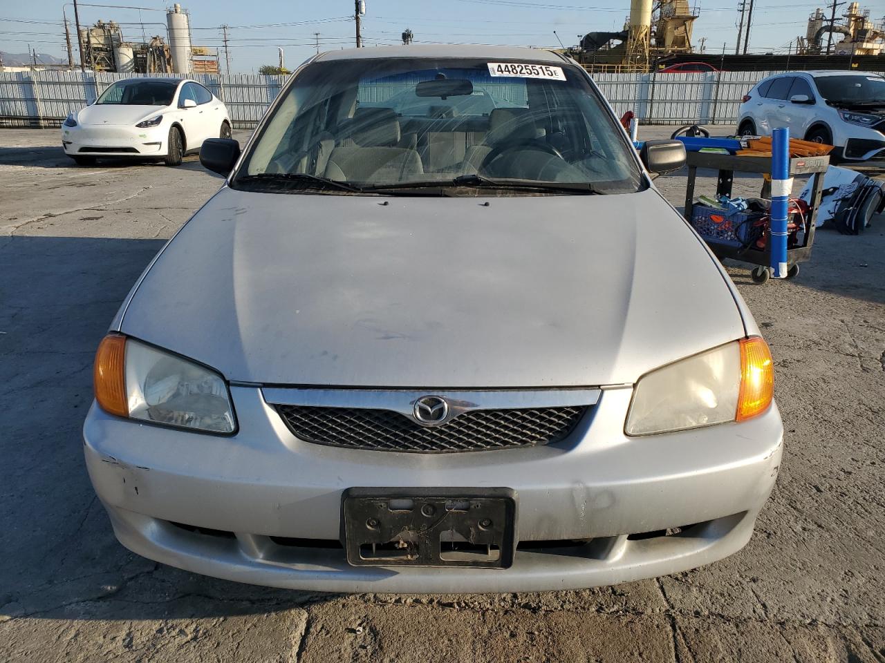2000 Mazda Protege VIN JM1BJ2224Y0240681 Copart auction photo, side damage thumbnail 5
