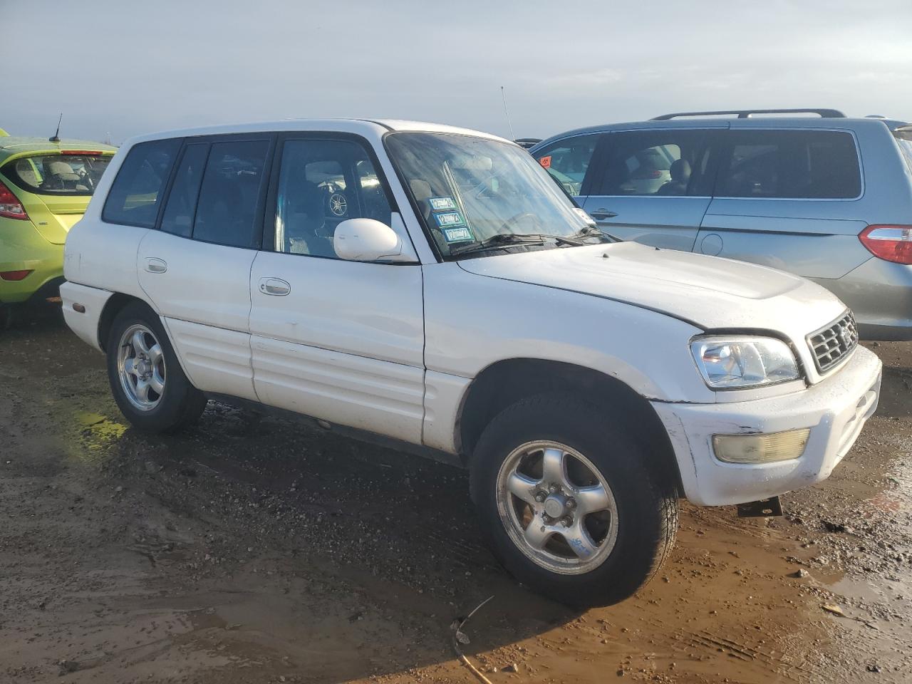 1999 Toyota RAV 4 VIN JT3GP10V7X7063436 Copart auction photo, side / rear end damage thumbnail 4