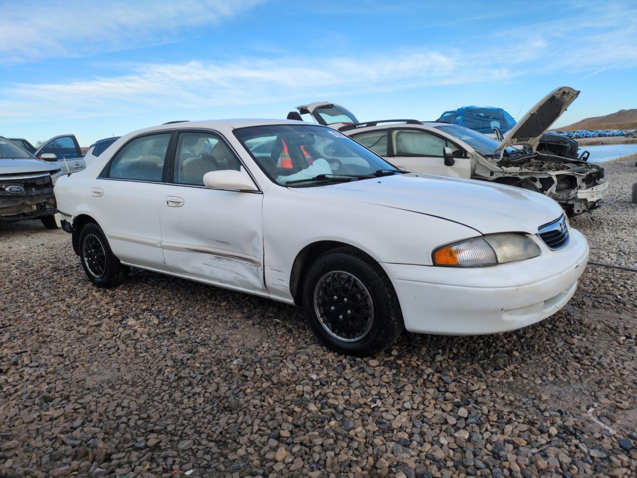 1999 Mazda 626 VIN 1YVGF22C9X5887587 Copart auction photo, rear end / side damage thumbnail 4