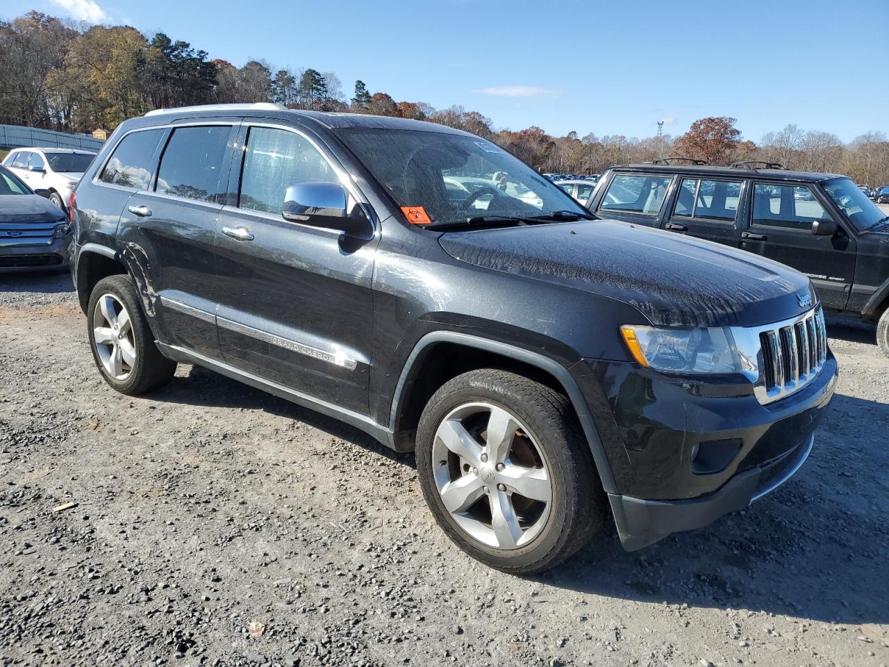 2012 Jeep Grand Cherokee VIN 1C4RJEBGXCC230207 Copart auction photo, side / damage history damage thumbnail 4