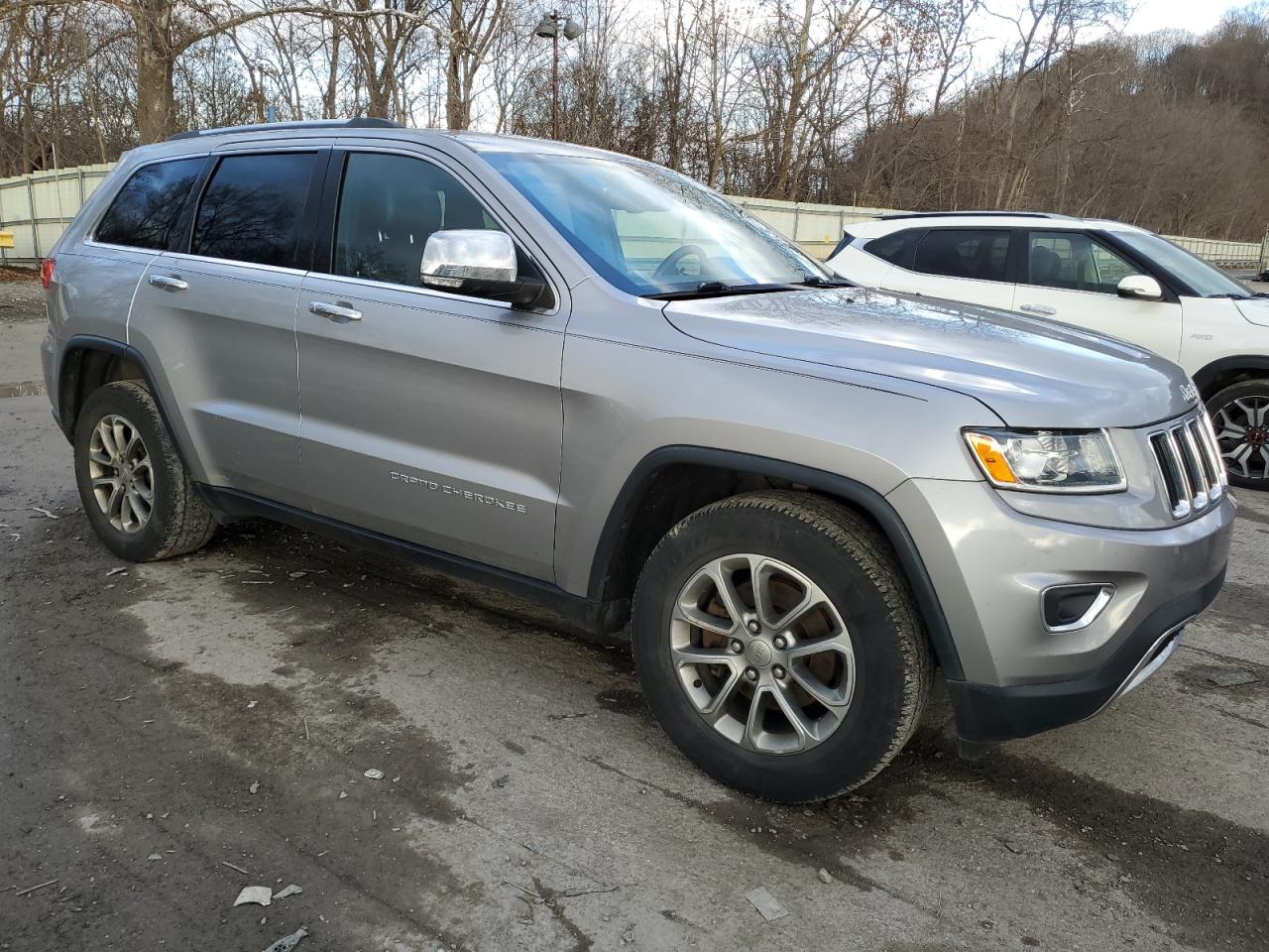2015 Jeep Grand Cherokee VIN 1C4RJFBG4FC711743 Copart auction photo, front end / side damage thumbnail 4