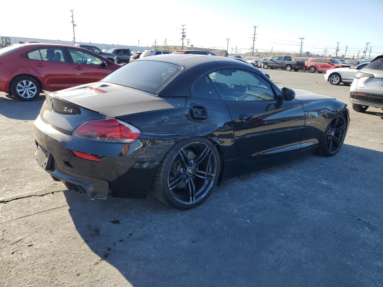 2011 BMW Z4 VIN WBALM1C58BE393909 Copart auction photo, rear end / side damage thumbnail 3