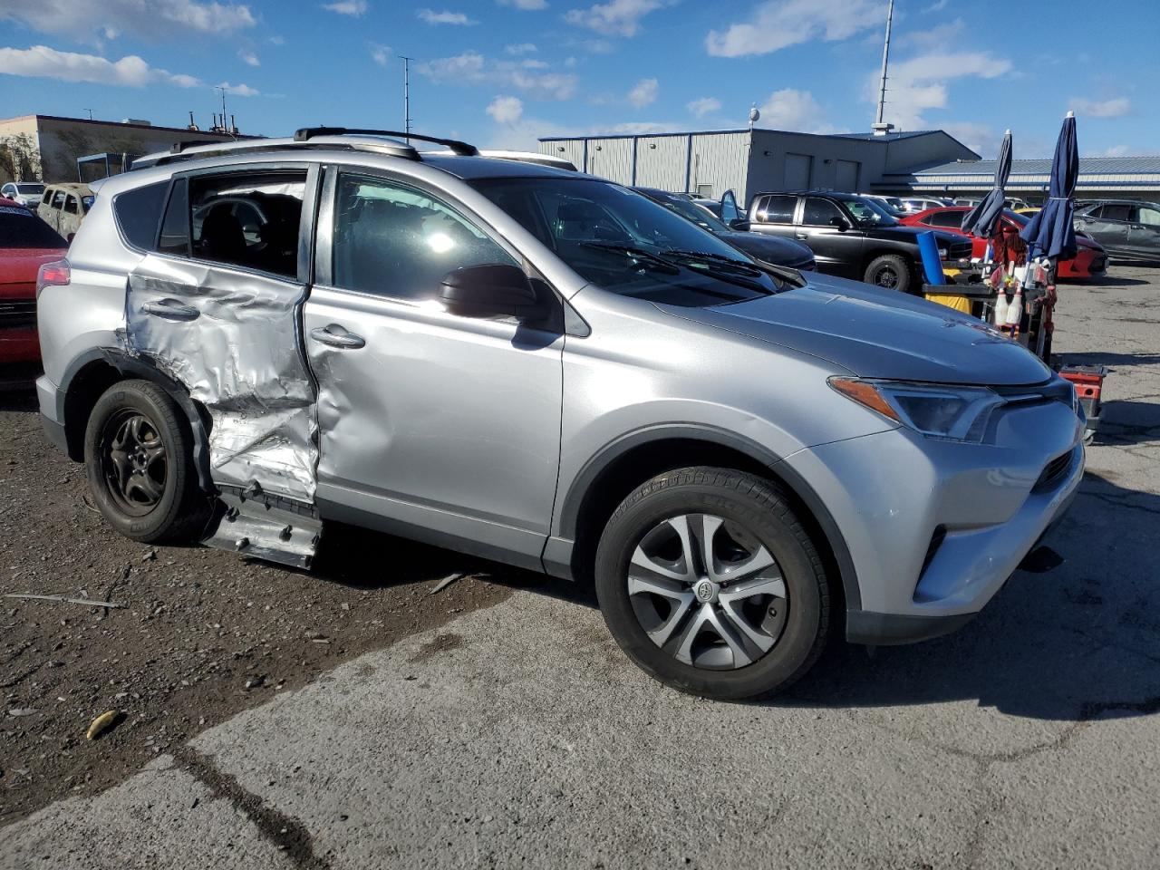 2016 Toyota RAV 4 VIN 2T3ZFREV6GW263047 Copart auction photo, side / rear end damage thumbnail 4