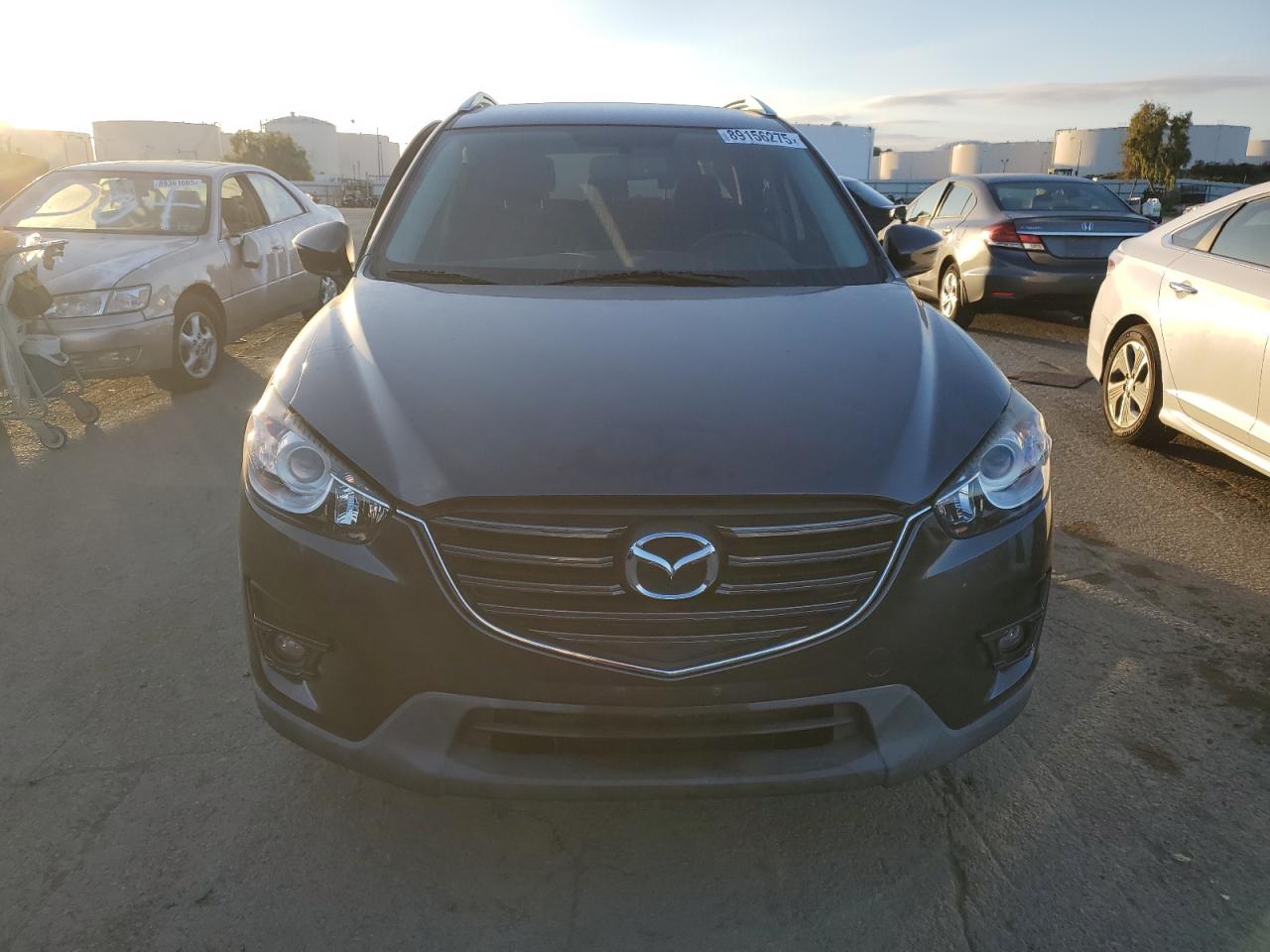 2016 Mazda CX-5 VIN JM3KE2CY8G0756538 Copart auction photo, side / front end damage thumbnail 5