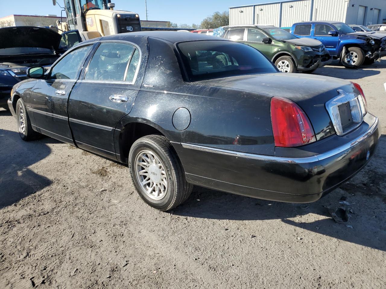 1999 Lincoln Town Car VIN 1LNHM82W4XY721047 Copart auction photo, rollover damage thumbnail 2