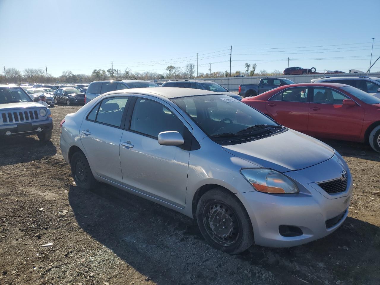 2010 Toyota Yaris VIN JTDBT4K34A1392197 Copart auction photo, side / front end damage thumbnail 4