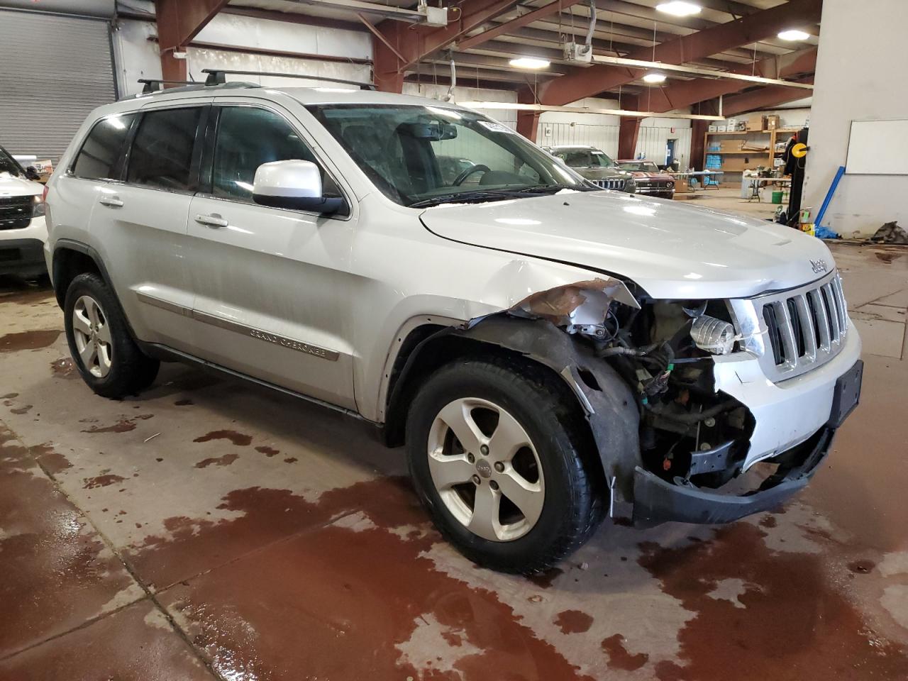 2012 Jeep Grand Cherokee VIN 1C4RJFAGXCC165043 Copart auction photo, side / front end damage thumbnail 4