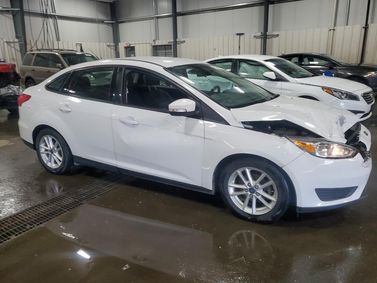 2015 Ford Focus VIN 1FADP3F28FL384128 Copart auction photo, front end / side damage thumbnail 4